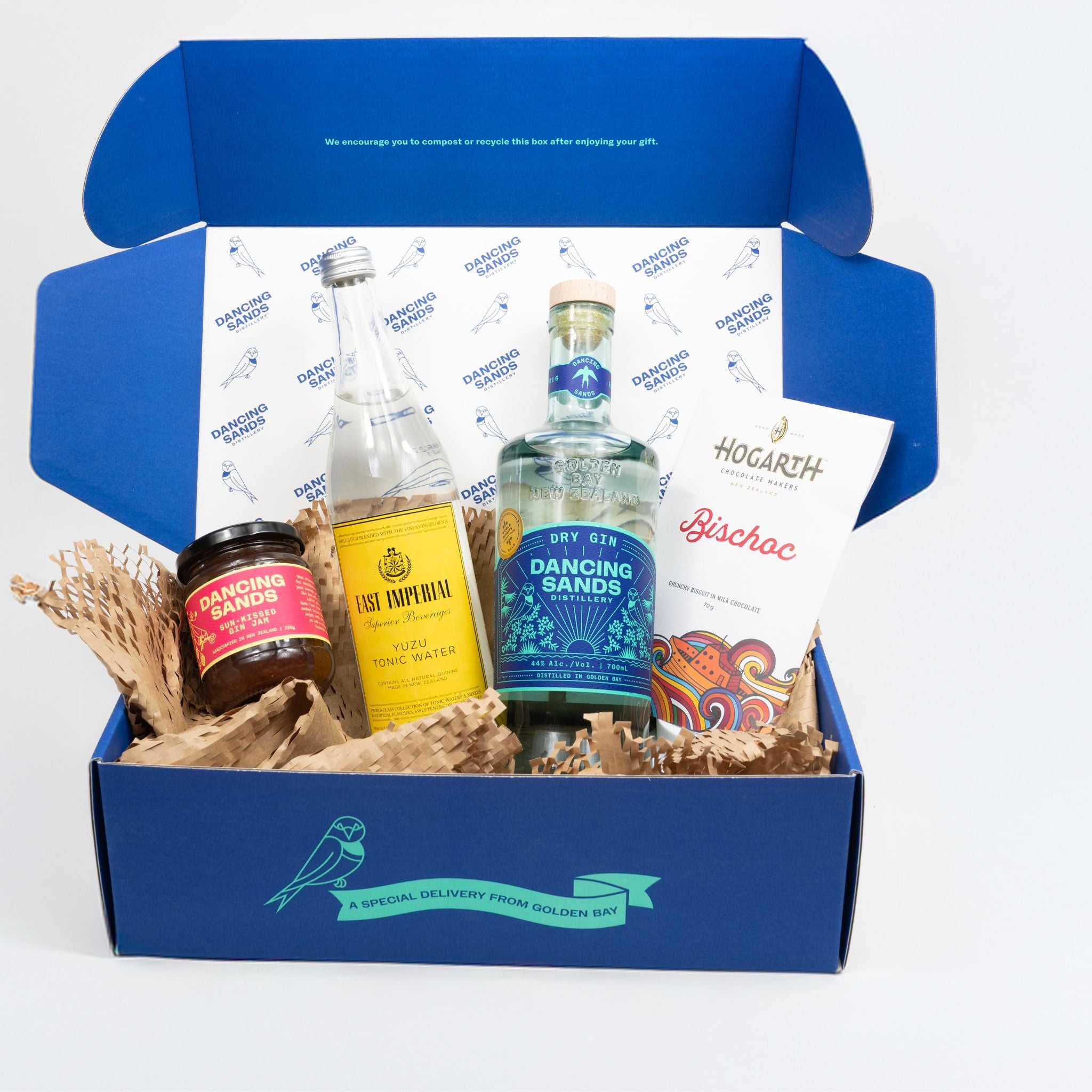 Blue gift box with bottles and snacks on a white background